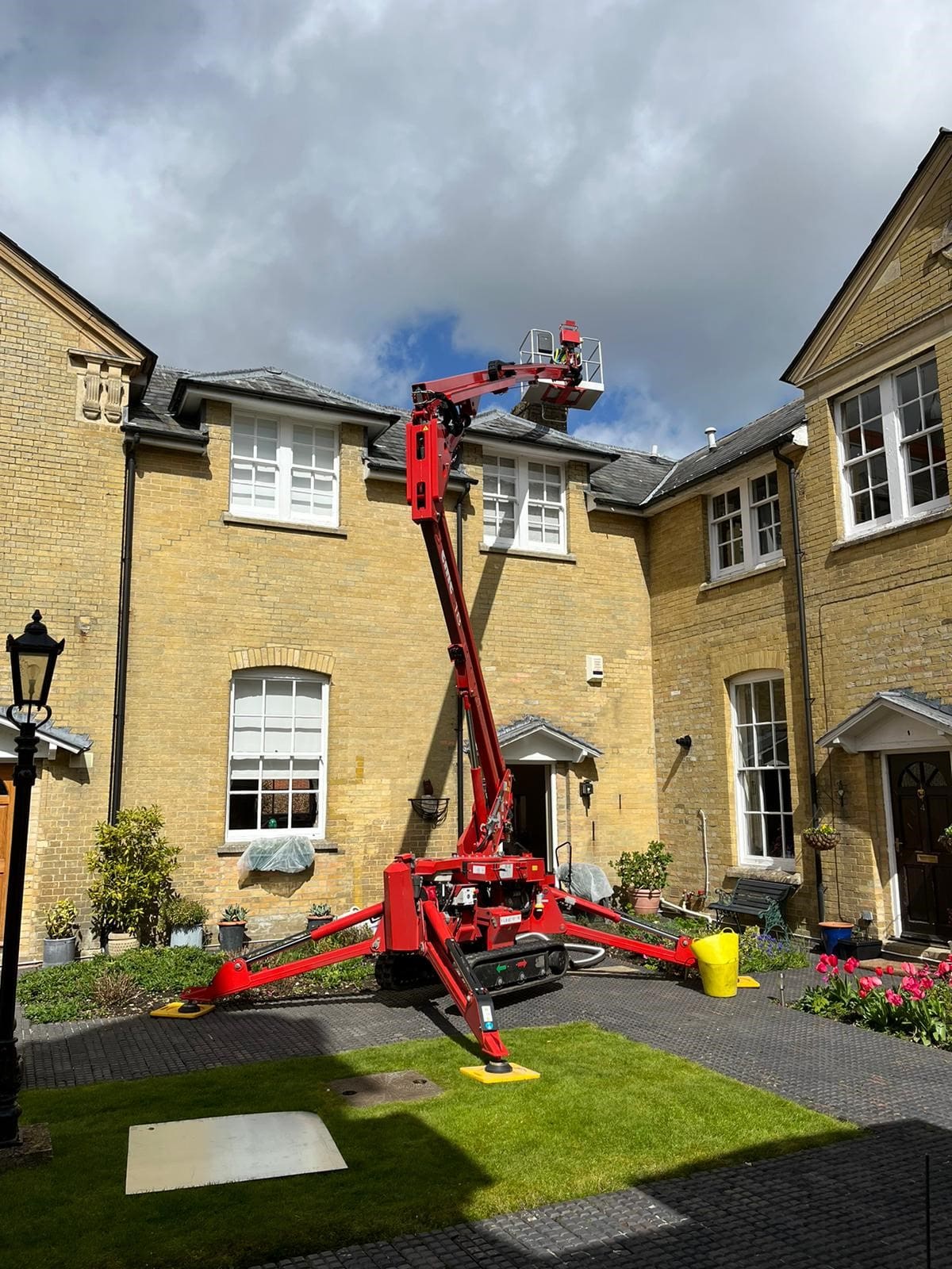Humphrey & Crockett with their cherry picker, repairing a chimney.